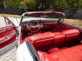 a red and white convertible car parked in a parking lot