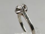 a close up of a ring with a diamond on it