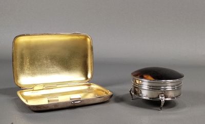 a small silver box with a black lid next to a small silver box with a black lid
