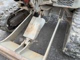a close up of a tractor that is parked in the dirt