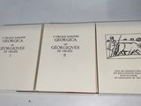three books are sitting on a table with a white table cloth