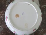 a white plate with pink flowers on it sitting on a table