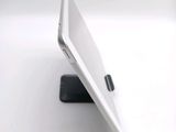 a white tablet computer sitting on top of a white table