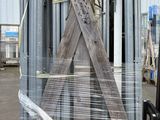 a forklift that is parked in front of a pile of steel poles