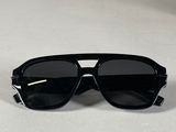 a pair of black sunglasses sitting on top of a white surface