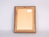 an old picture frame with a picture hanging on the wall