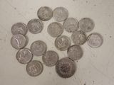 a pile of silver coins on a white surface
