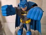 a figurine of a batman with a blue cape