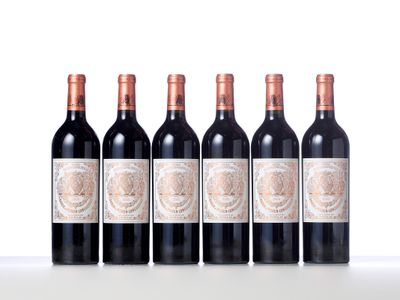 six bottles of red wine lined up in a row on a table