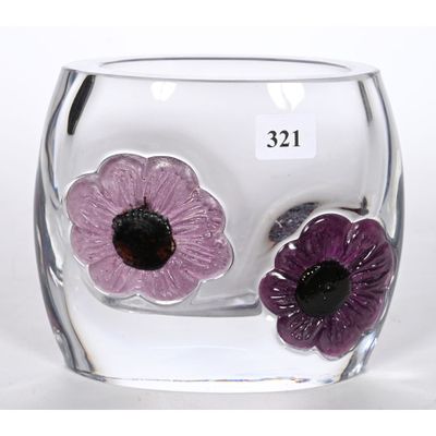 un vase en verre contenant deux fleurs violettes