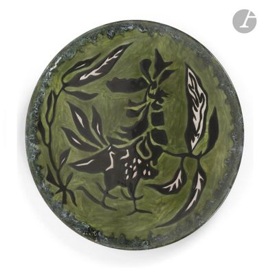 une assiette verte ornée de motifs en noir et blanc