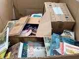a cardboard box full of books in the middle of a warehouse