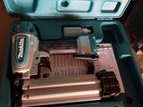 a blue box with a stapler and a stapler in it