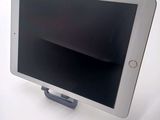 a tablet that is sitting on a stand on a table