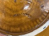 a close up of a brown bowl on a table