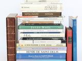 several books are stacked on top of each other on a table