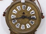 a clock with roman numerals hanging on the wall