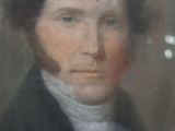 portrait of a man in a black coat and a white shirt