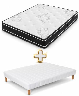 a white mattress and a black and white bed with a gold cross on it