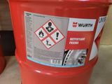a red barrel with a sticker on it sitting on the floor