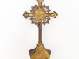 an old metal cross hanging on a wall on a white background