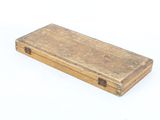 a small wooden box with a handle on a white surface