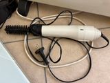 a hair dryer that is sitting on the floor next to a laptop