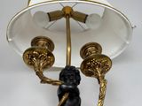 a lamp that has a statue on top of it