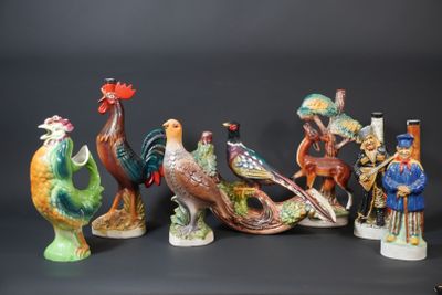 several figurines of different types of birds on a black background