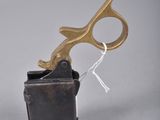 a gold pair of scissors sitting on top of a black box