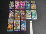 a lot of pokemon cards on the table next to a ruler