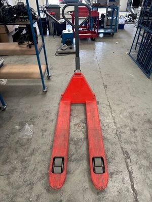 a forklift in a warehouse with a fork on it