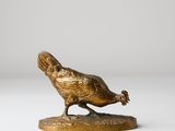 bronze sculpture of a bird on a base