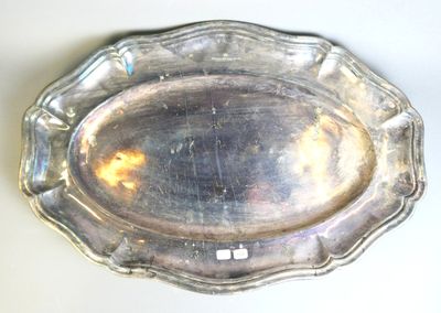 a silver plate on a table with a white background