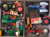 a box full of toy tractors and other toy vehicles