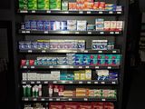a display of cigarettes in a store with a sign above it