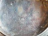 a close up of a silver pocket watch on a table