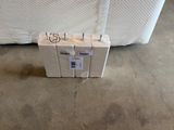 a box that is sitting on the floor in front of a bed