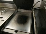 a dirty stove in the middle of a dirty kitchen