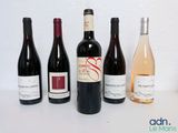 several bottles of wine are lined up on a table
