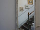 un miroir accroché au mur à côté d'un escalier