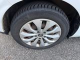 a close up of a tire on a white car
