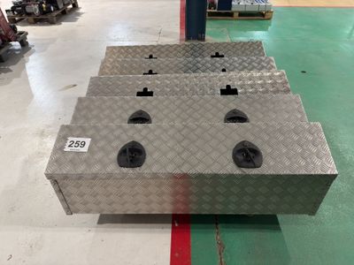 a metal box with four holes on it in a warehouse