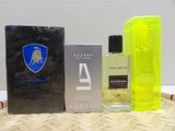 two bottles of perfume sitting on top of a table next to a box