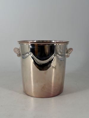 a silver ice bucket with a handle on a table