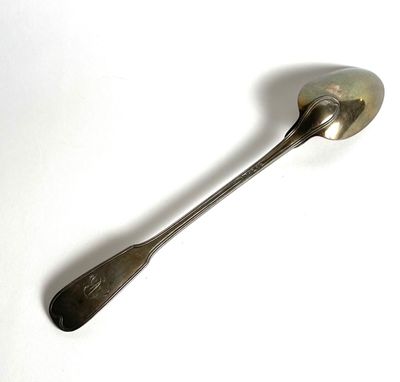 a spoon that is sitting on a white surface