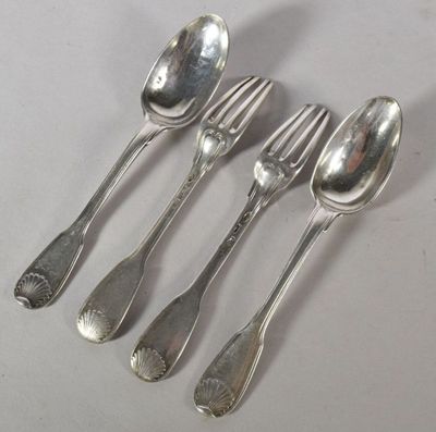 four silver spoons and a fork are lined up on a table