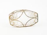 an image of a clear glass ring with gold accents on a white background