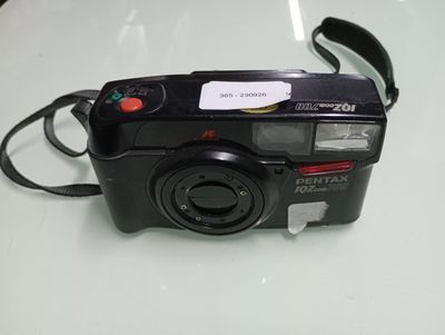 a black camera on a white table with a tag on it