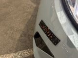 a sticker on the front of a white car